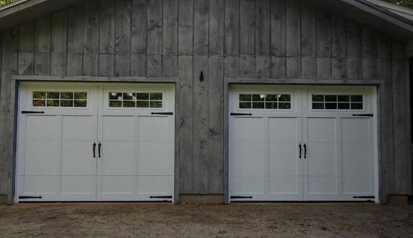 Two white garage doors, enhancing the overall aesthetic of the property.